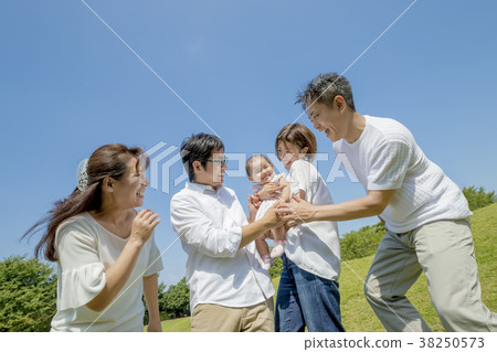 Three generation family playing in the park 38250573