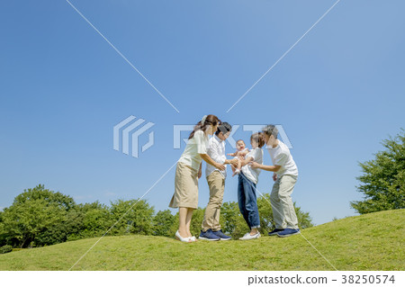 Three generation family playing in the park 38250574