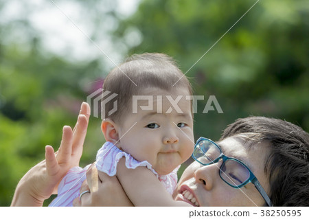 Father and daughter playing in the park 38250595