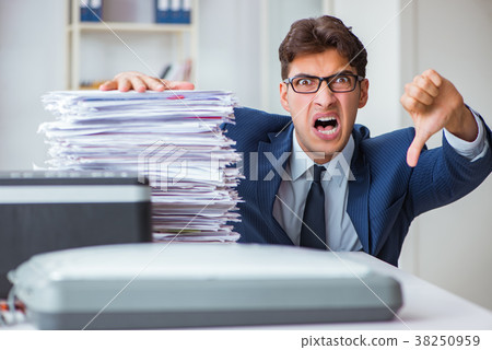 Businessman making copies in copying machine Businessman making copies in copying machine 38250959