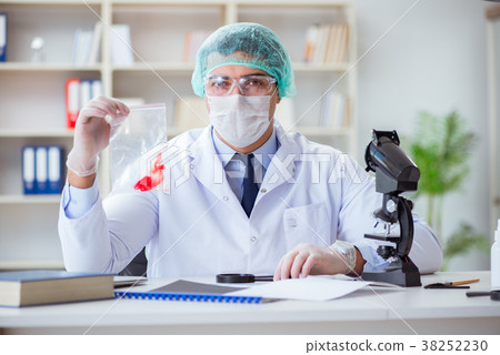 Forensics investigator working in lab on crime Forensics investigator working in lab on crime 38252230