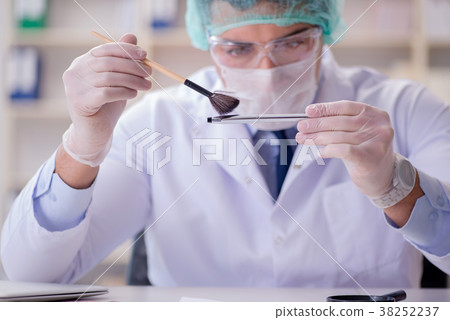 Forensics investigator working in lab on crime Forensics investigator working in lab on crime 38252237
