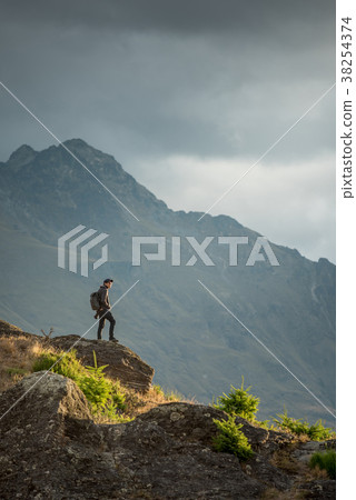 male photographer looking at scenery in Queenstown 38254374