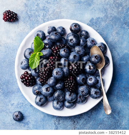 Blueberry and blackberry berries on a white plate 38255412
