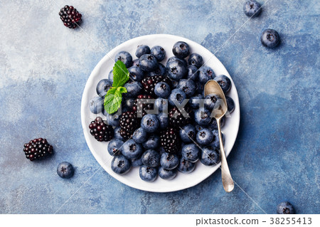 Blueberry and blackberry berries on a white plate 38255413