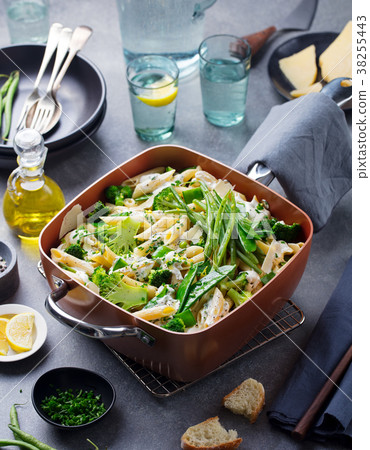 Pasta with green vegetables and creamy sauce 38255443