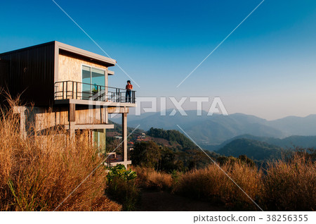 Modern wooden country house on grass hill 38256355