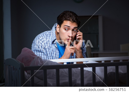 Happy dad looking after newborn baby at night Happy dad looking after newborn baby at night 38256751