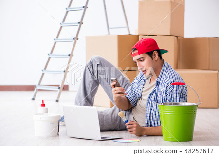 Young painter contractor choosing colors for home Young painter contractor choosing colors for home 38257612
