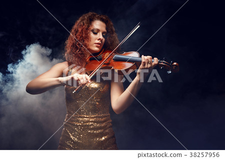 Violinist girl performs on stage. Violinist girl performs on stage. 38257956