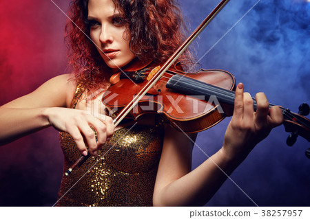 Violinist girl performs on stage. 38257957