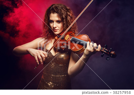 Violinist girl performs on stage. 38257958