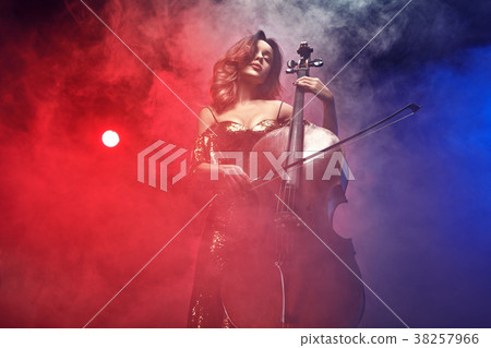 The cellist girl performs on stage. 38257966