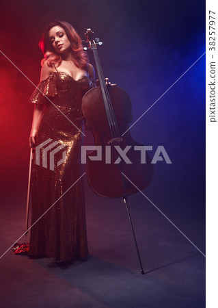 The cellist girl performs on stage. The cellist girl performs on stage. 38257977