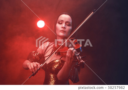 Violinist girl performs on stage. Violinist girl performs on stage. 38257982