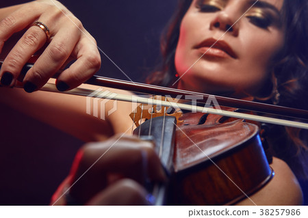 A girl plays the viola performs on stage. A girl plays the viola performs on stage. 38257986