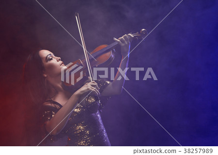 Violinist girl performs on stage. Violinist girl performs on stage. 38257989