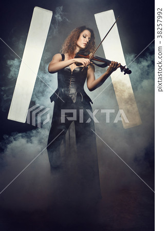 Violinist girl performs on stage. 38257992