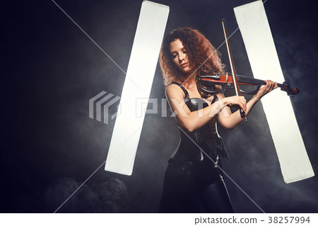 Violinist girl performs on stage. 38257994
