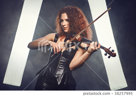 Violinist girl performs on stage. 38257995
