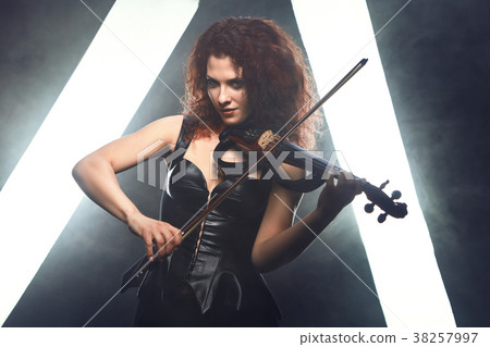 Violinist girl performs on stage. Violinist girl performs on stage. 38257997