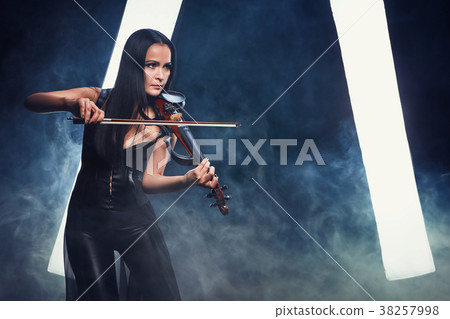 Violinist girl performs on stage. Violinist girl performs on stage. 38257998