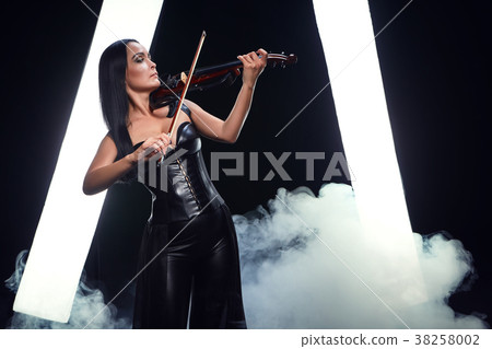 Violinist girl performs on stage. 38258002