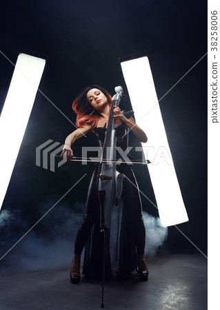 The cellist girl performs on stage. 38258006