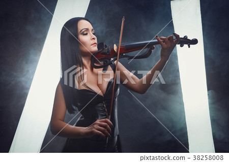 Violinist girl performs on stage. 38258008