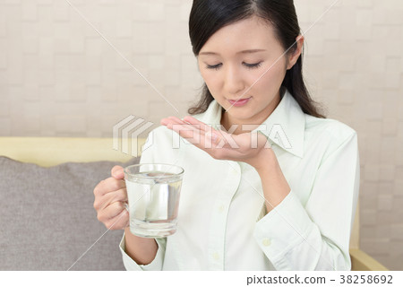 Woman taking medicine Woman taking medicine 38258692