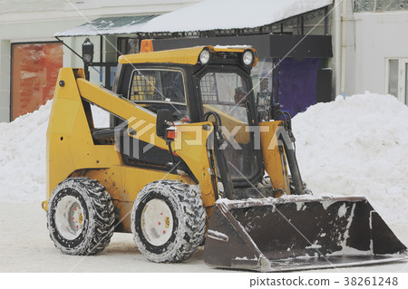 Clearing snow from the road with bulldozer in the Clearing snow from the road with bulldozer in the 38261248