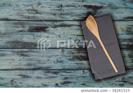 Wooden spoon and kitchen towel on turquoise vintage wood Wooden spoon and kitchen towel on turquoise vintage wood 38261525