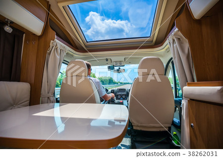 Man driving on a road in the Camper Van RV 38262031