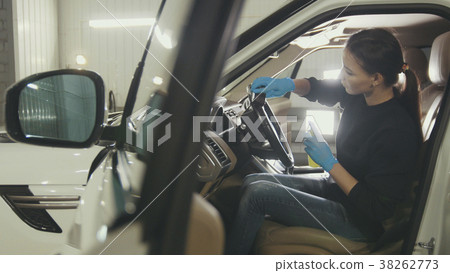 Young woman in blue gloves is cleaning interior of Young woman in blue gloves is cleaning interior of 38262773