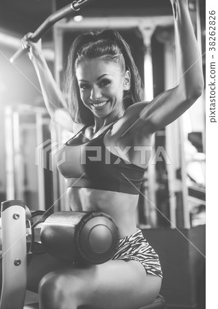 Sexy athletic young girl training back in gym Sexy athletic young girl training back in gym 38262826