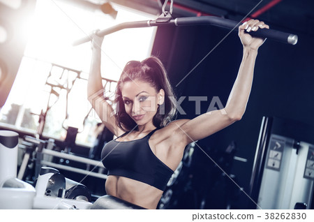 Sexy athletic young girl training back in gym Sexy athletic young girl training back in gym 38262830