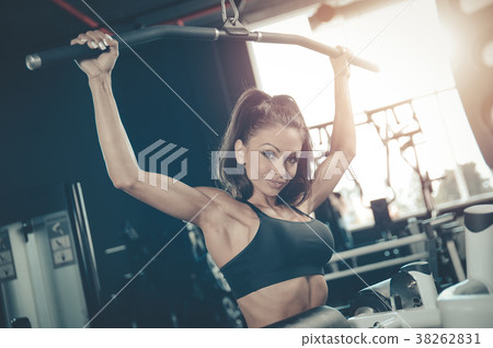 Sexy athletic young girl training back in gym Sexy athletic young girl training back in gym 38262831