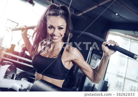Sexy athletic young girl training back in gym Sexy athletic young girl training back in gym 38262833
