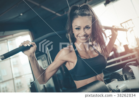 Sexy athletic young girl training back in gym Sexy athletic young girl training back in gym 38262834