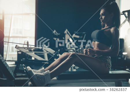 Sexy athletic young girl training back in gym Sexy athletic young girl training back in gym 38262837