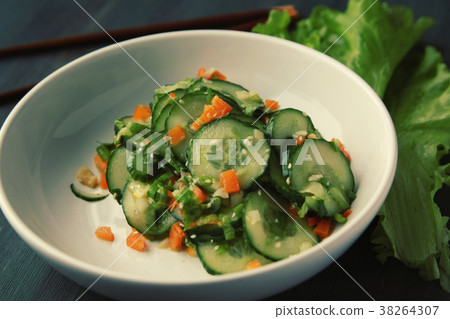 Asian cucumber salad on the white plate. Close up. 38264307