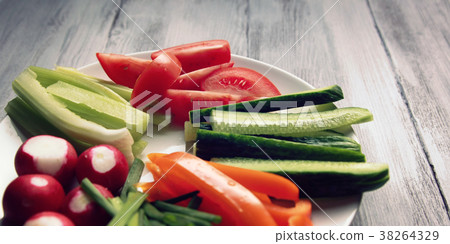 White plate with vegetables for a vegetarian salad White plate with vegetables for a vegetarian salad 38264329