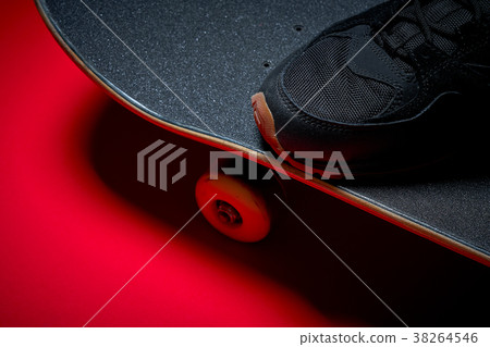 shoes and used skateboard on a red background shoes and used skateboard on a red background 38264546