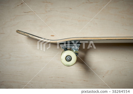 side view of skateboard on a wooden background 38264554