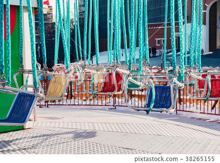 Empty colored seats of carousel Empty colored seats of carousel 38265155