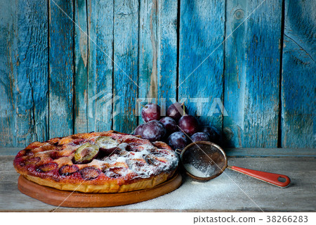 Plum cake, fresh plums and a strainer 38266283