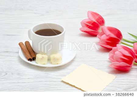 Three pink tulips, mug of coffee and cinamon Three pink tulips, mug of coffee and cinamon 38266640