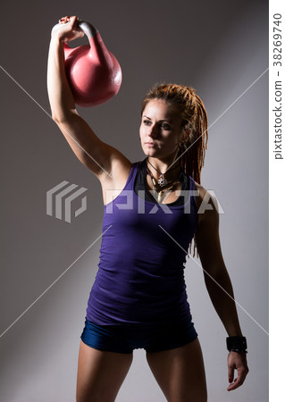 Portrait of young attractive female doing kettle Portrait of young attractive female doing kettle 38269740