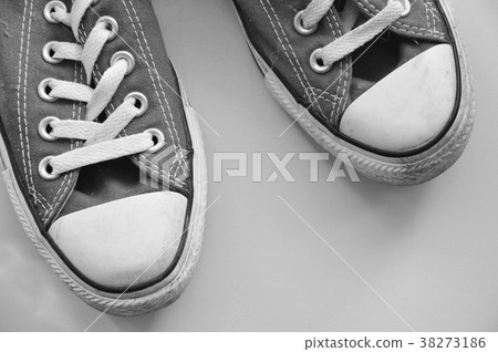 old sneakers on tile floor in monochrome tone 38273186