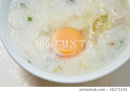 Rice porridge with pork topping egg yolk on bowl Rice porridge with pork topping egg yolk on bowl 38273239